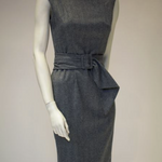 Grey herringbone wool cashmere shift dress on a mannequin with matching waterfall belt